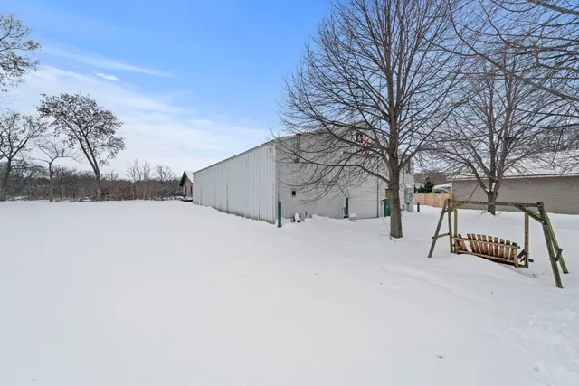 a view of house with yard and covered with snow