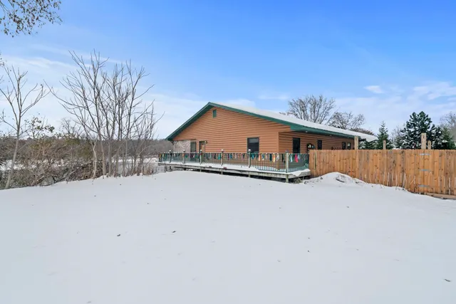 a aerial view of a house with a yard and lake view
