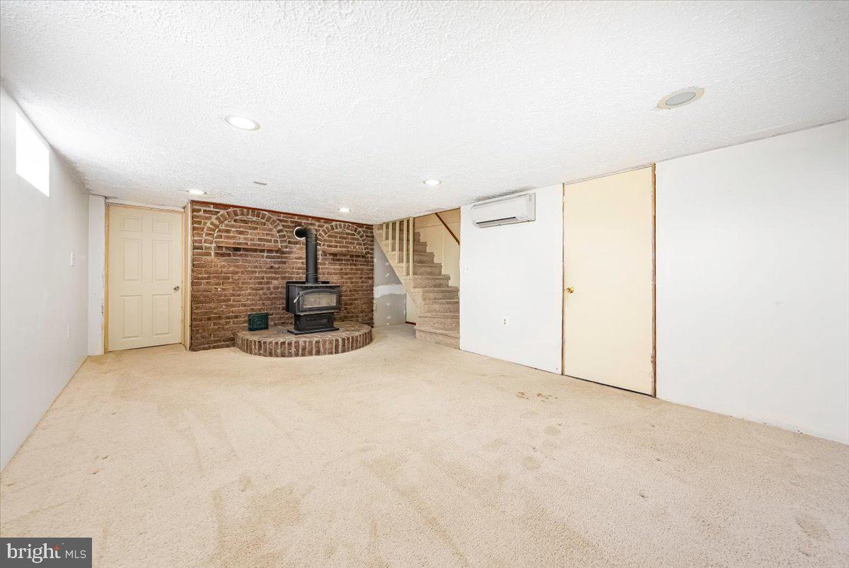 5968 Grove Hill Road Frederick, MD 21703 - Photo 17 of 43 Basement with Woodburing Stove