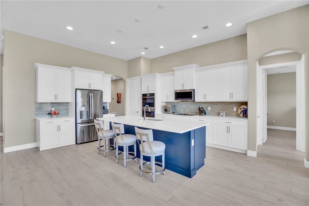 105 Night Hawk Way Sebastian, FL 32958 - Photo 11 of 36 a kitchen with appliances a sink a counter top space and cabinets