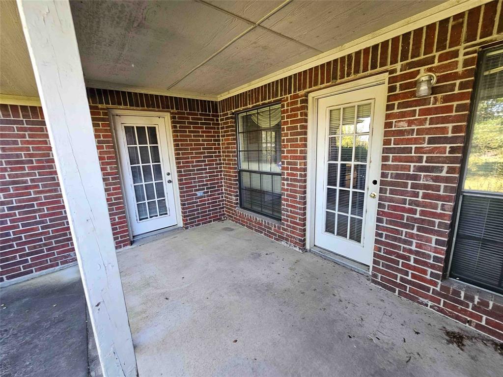 503 Pin Oak Drive Terrell, TX 75161 - Photo 13 of 23 a view of an empty room with wooden floor and a fireplace