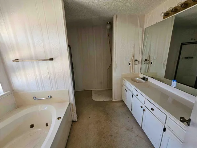 a bathroom with a double vanity sink and a bathtub