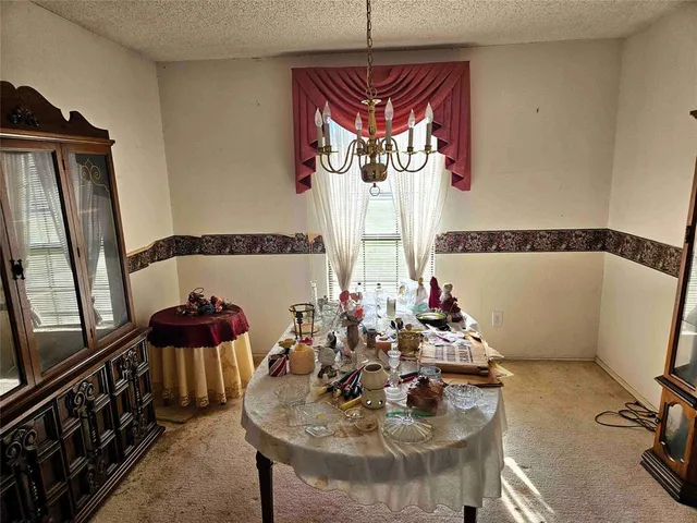 a view of a dining room with furniture and window