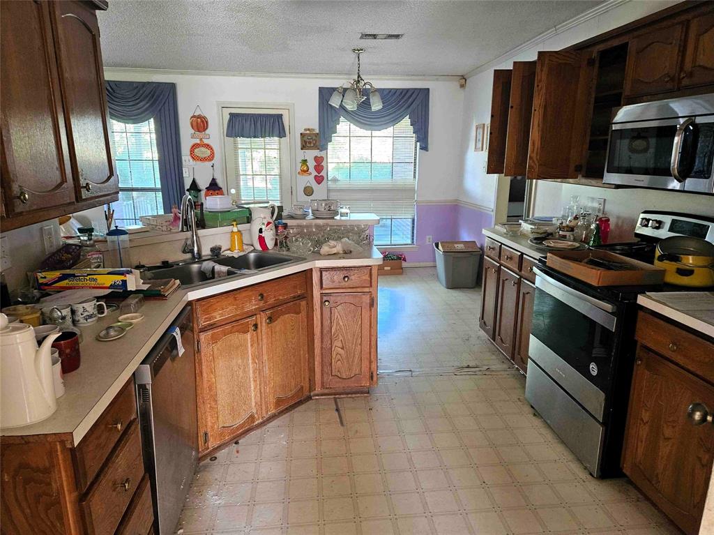 503 Pin Oak Drive Terrell, TX 75161 - Photo 8 of 23 a kitchen with a sink stove and microwave