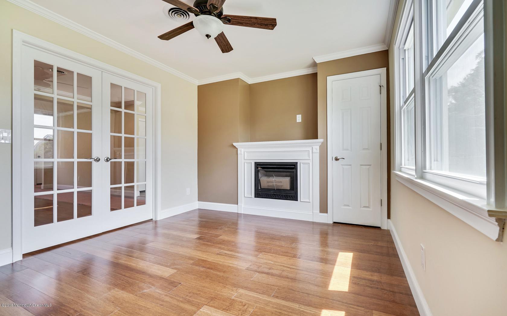 7 Coventry Road Toms River, NJ 08757 - Photo 16 of 34 a view of an empty room with a fireplace and a window