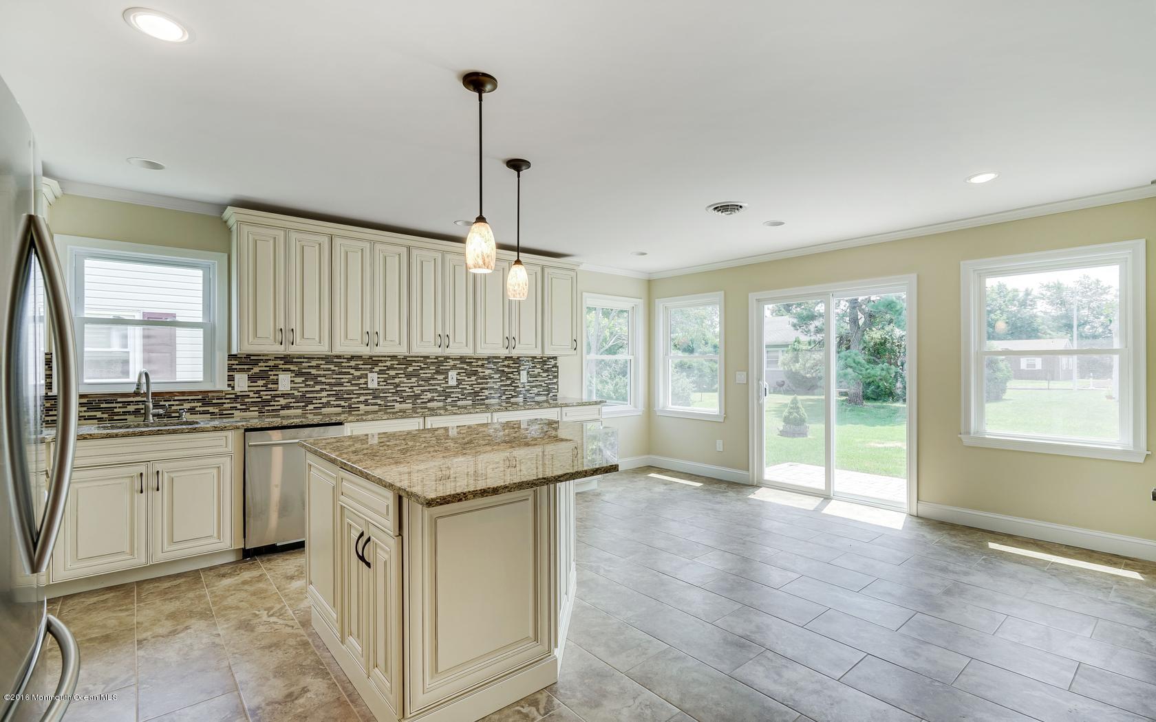 7 Coventry Road Toms River, NJ 08757 - Photo 19 of 34 a kitchen with stainless steel appliances granite countertop a stove a sink a refrigerator and island