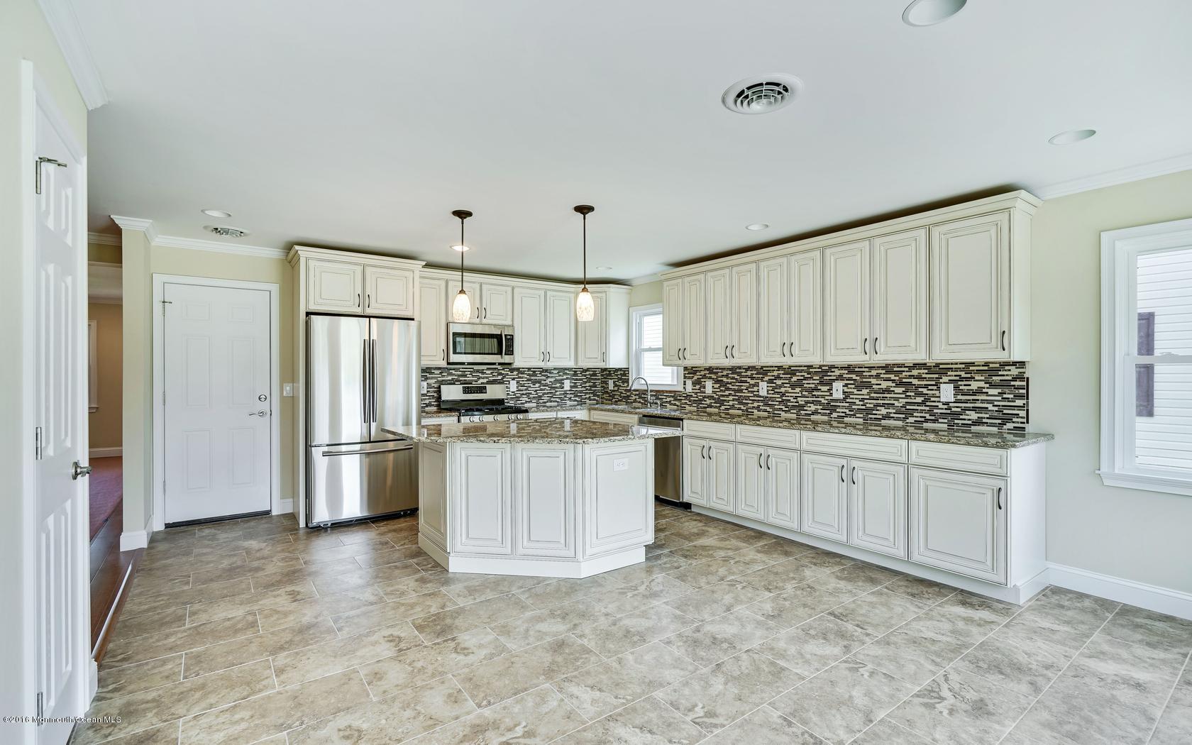 7 Coventry Road Toms River, NJ 08757 - Photo 20 of 34 a kitchen with white cabinets and stainless steel appliances