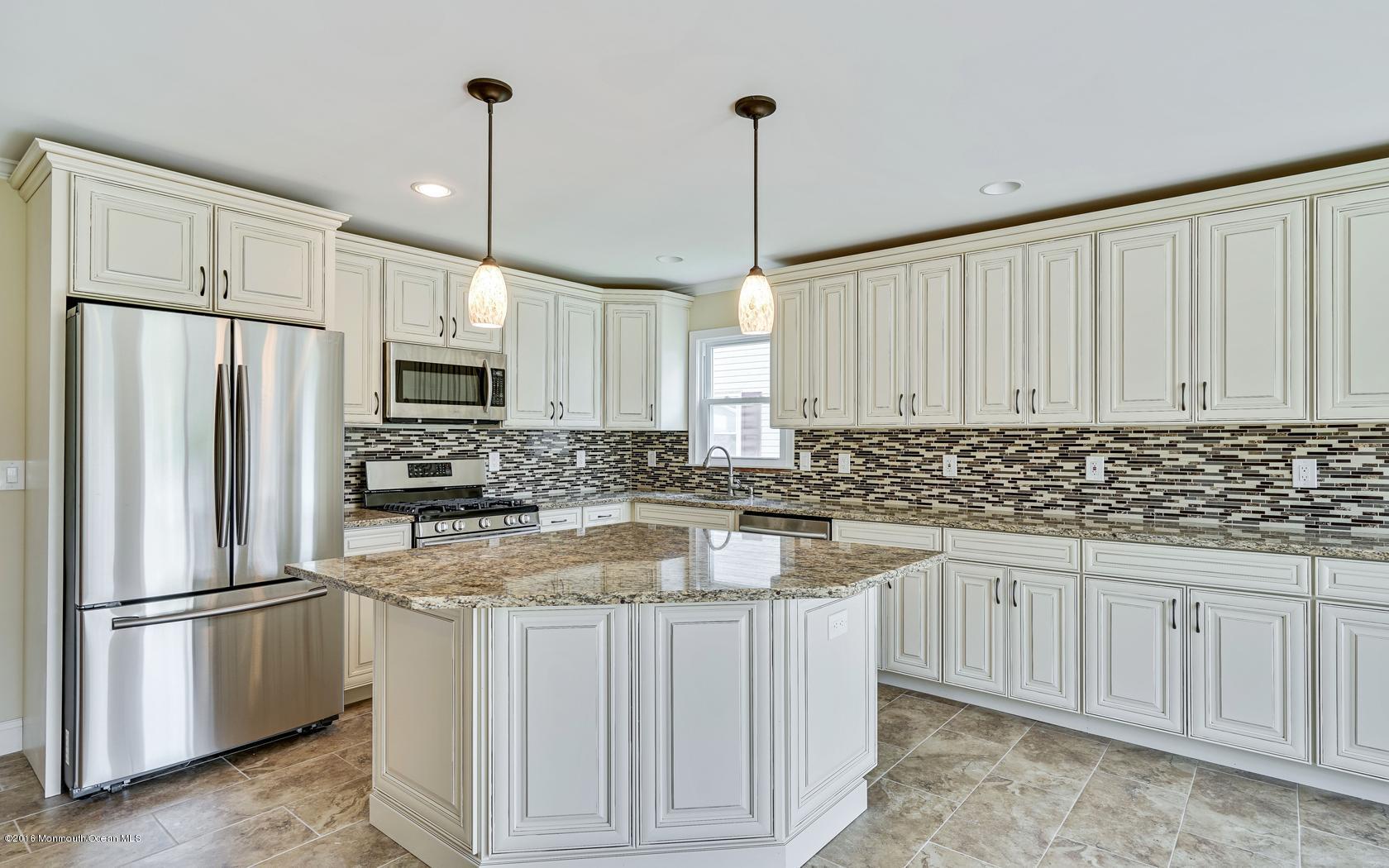 7 Coventry Road Toms River, NJ 08757 - Photo 2 of 34 a kitchen with white cabinets sink and stainless steel appliances