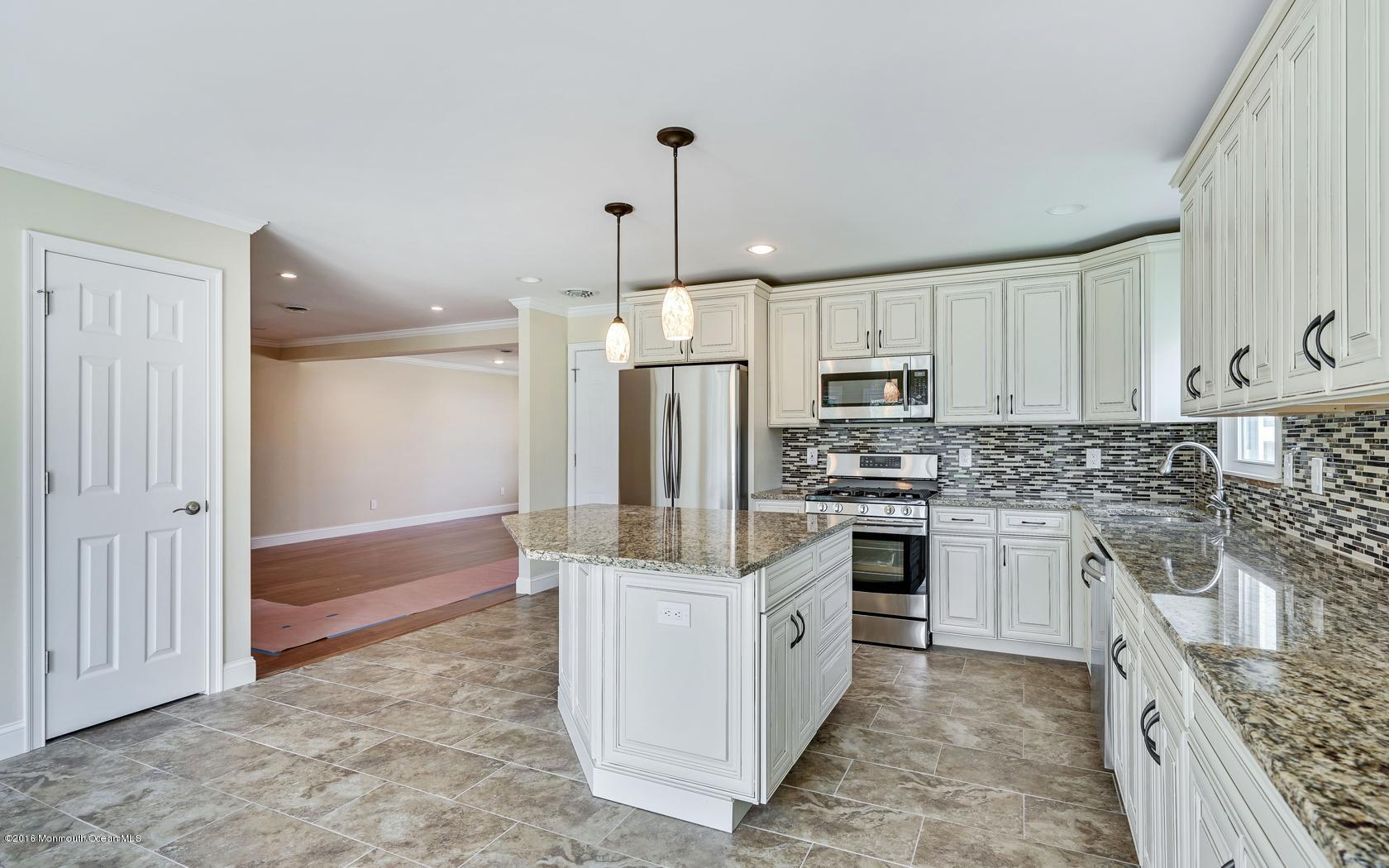 7 Coventry Road Toms River, NJ 08757 - Photo 22 of 34 a kitchen with kitchen island granite countertop a sink stove and refrigerator