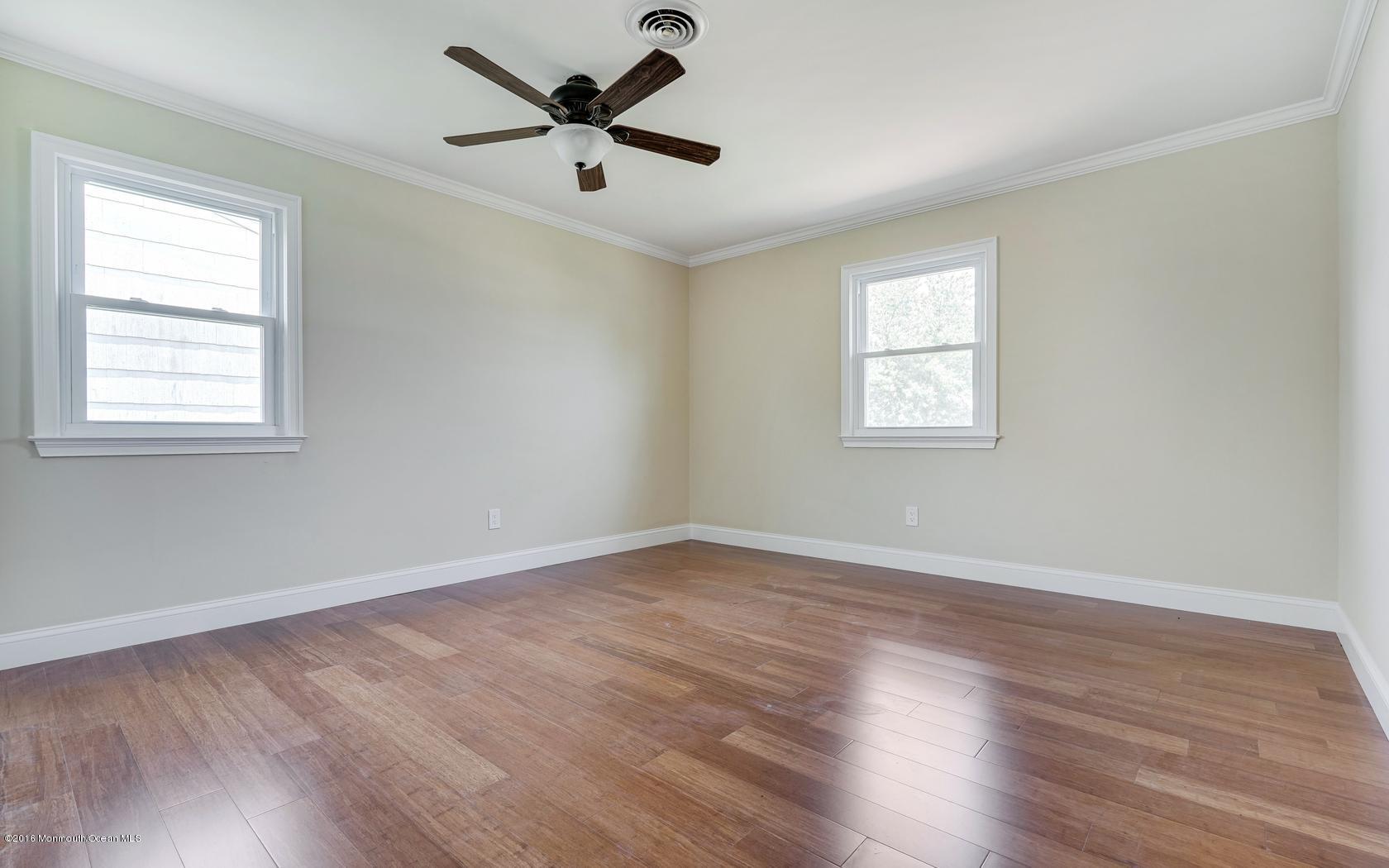 7 Coventry Road Toms River, NJ 08757 - Photo 33 of 34 an empty room with wooden floor and windows