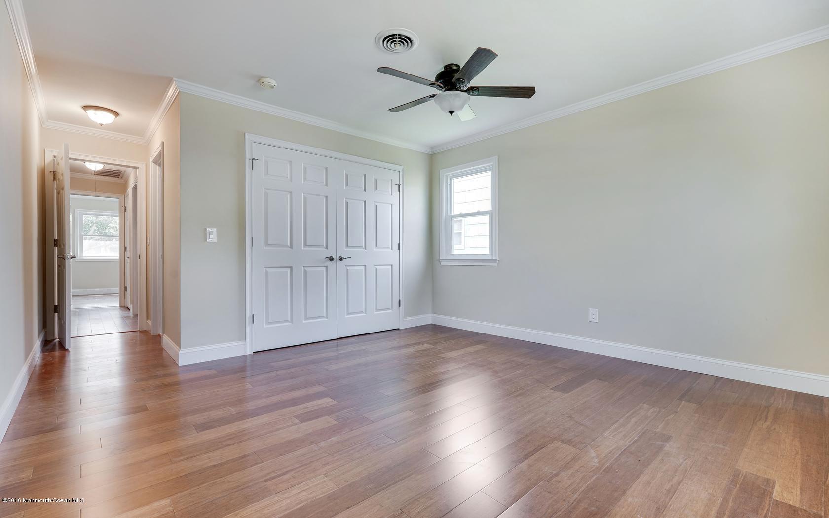 7 Coventry Road Toms River, NJ 08757 - Photo 34 of 34 an empty room with wooden floor and windows