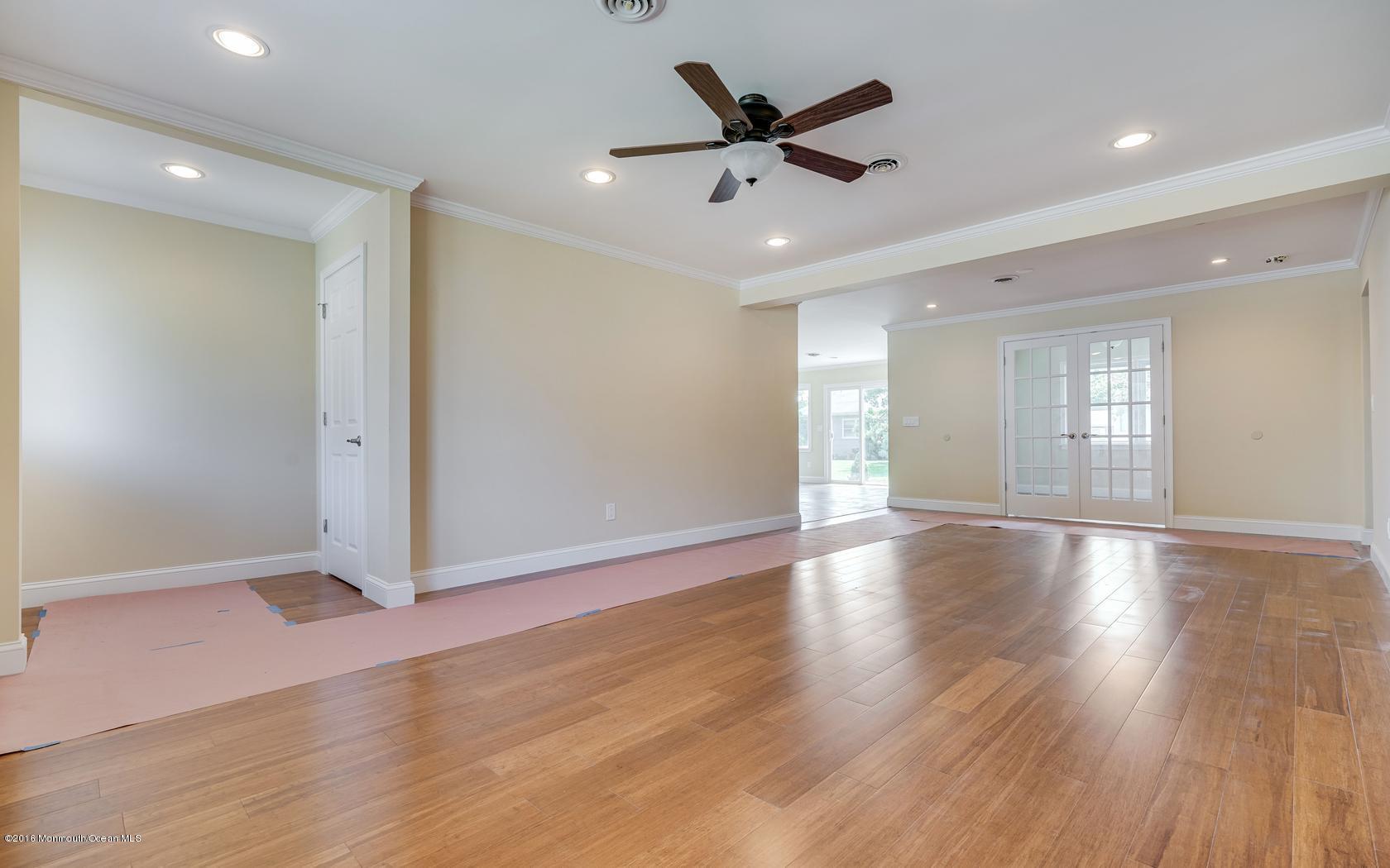 7 Coventry Road Toms River, NJ 08757 - Photo 10 of 34 a view of an empty room with wooden floor and a ceiling fan