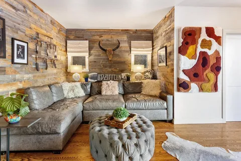 a living room with furniture and a potted plant