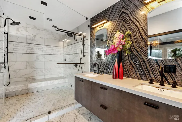a bathroom with a tub a sink and a large mirror