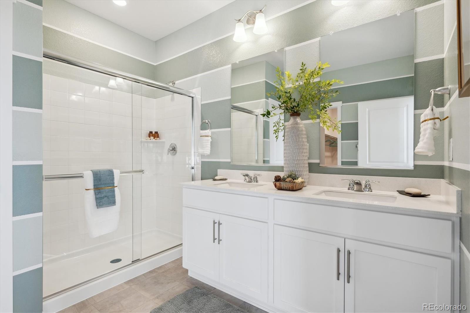 4203 Sandstone Drive Mead, CO 80504 - Photo 24 of 26 a bathroom with a double vanity sink mirror and shower