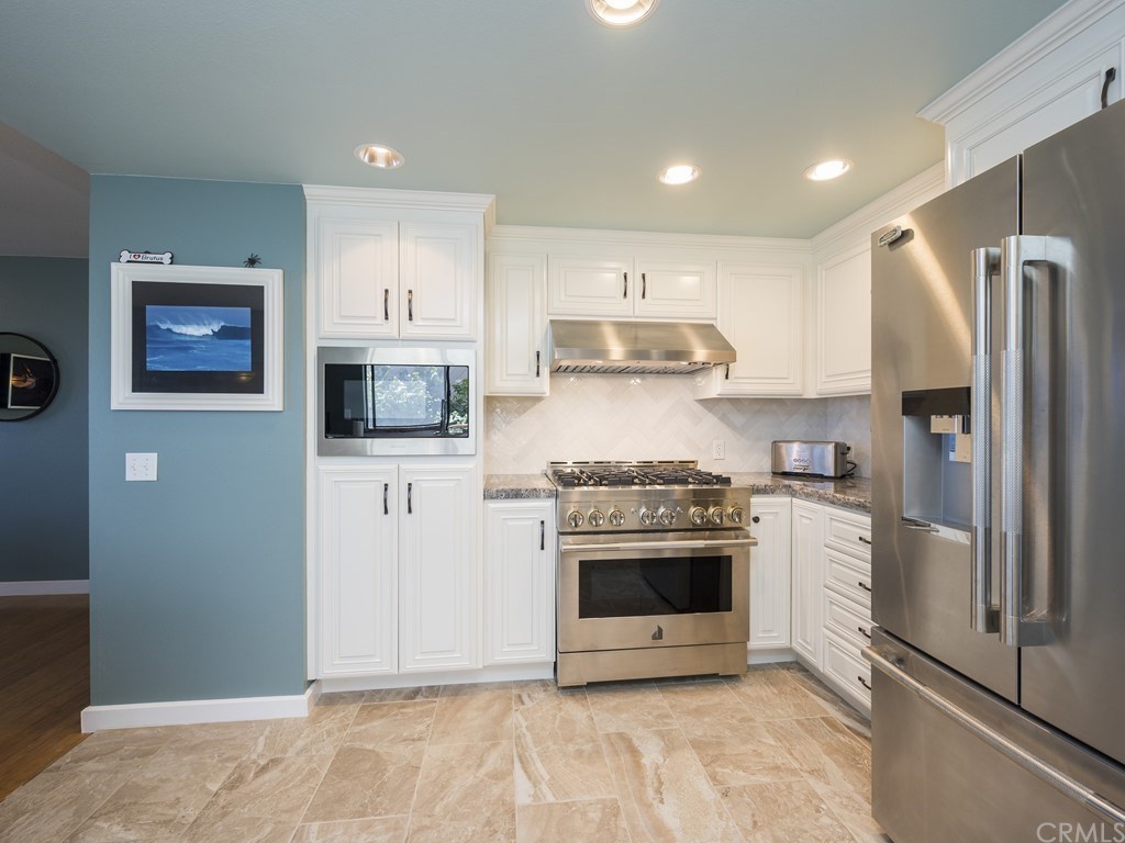 2630 Maple Avenue Morro Bay, CA 93442 - Photo 15 of 49 a kitchen with stainless steel appliances a stove a refrigerator and a microwave
