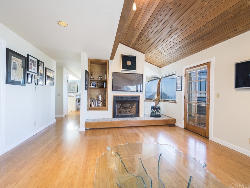 2630 Maple Avenue Morro Bay, CA 93442 - Photo 18 of 49 a view of a livingroom with a fireplace wooden floor and window