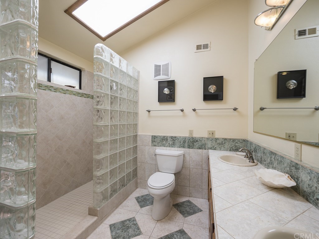 2630 Maple Avenue Morro Bay, CA 93442 - Photo 29 of 49 a bathroom with a toilet sink and mirror