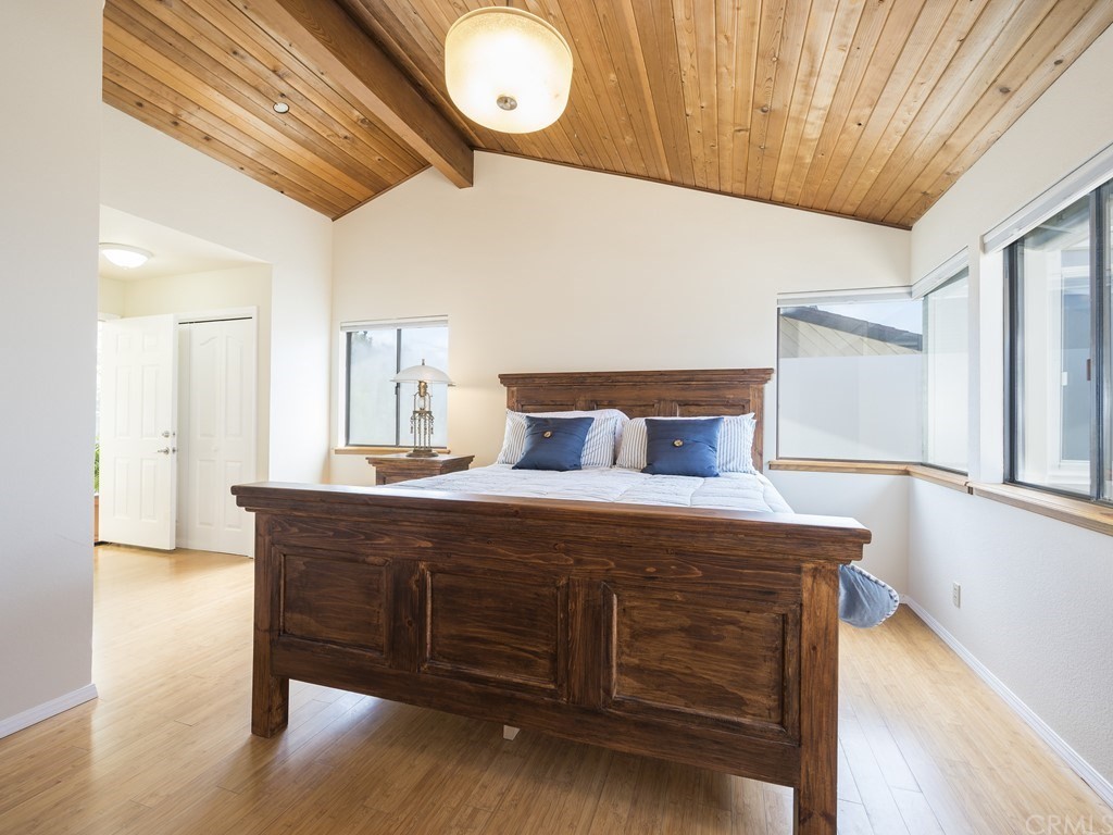 2630 Maple Avenue Morro Bay, CA 93442 - Photo 32 of 49 a bedroom with a bed and wooden floor