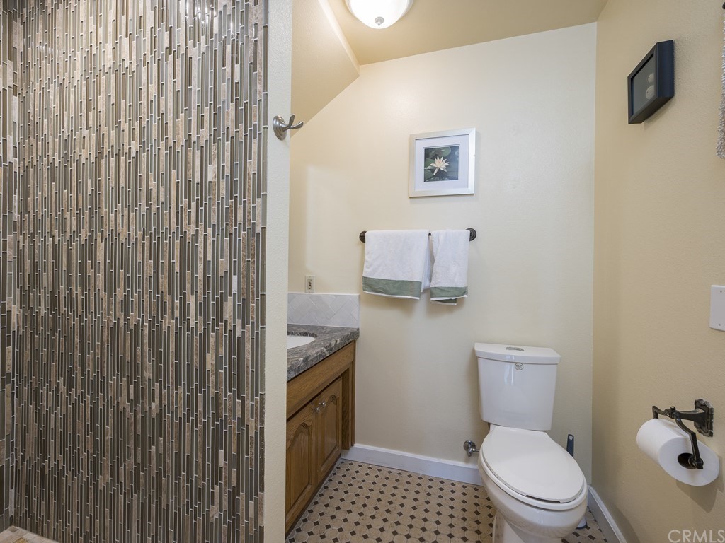 2630 Maple Avenue Morro Bay, CA 93442 - Photo 38 of 49 a bathroom with a toilet and a shower curtain