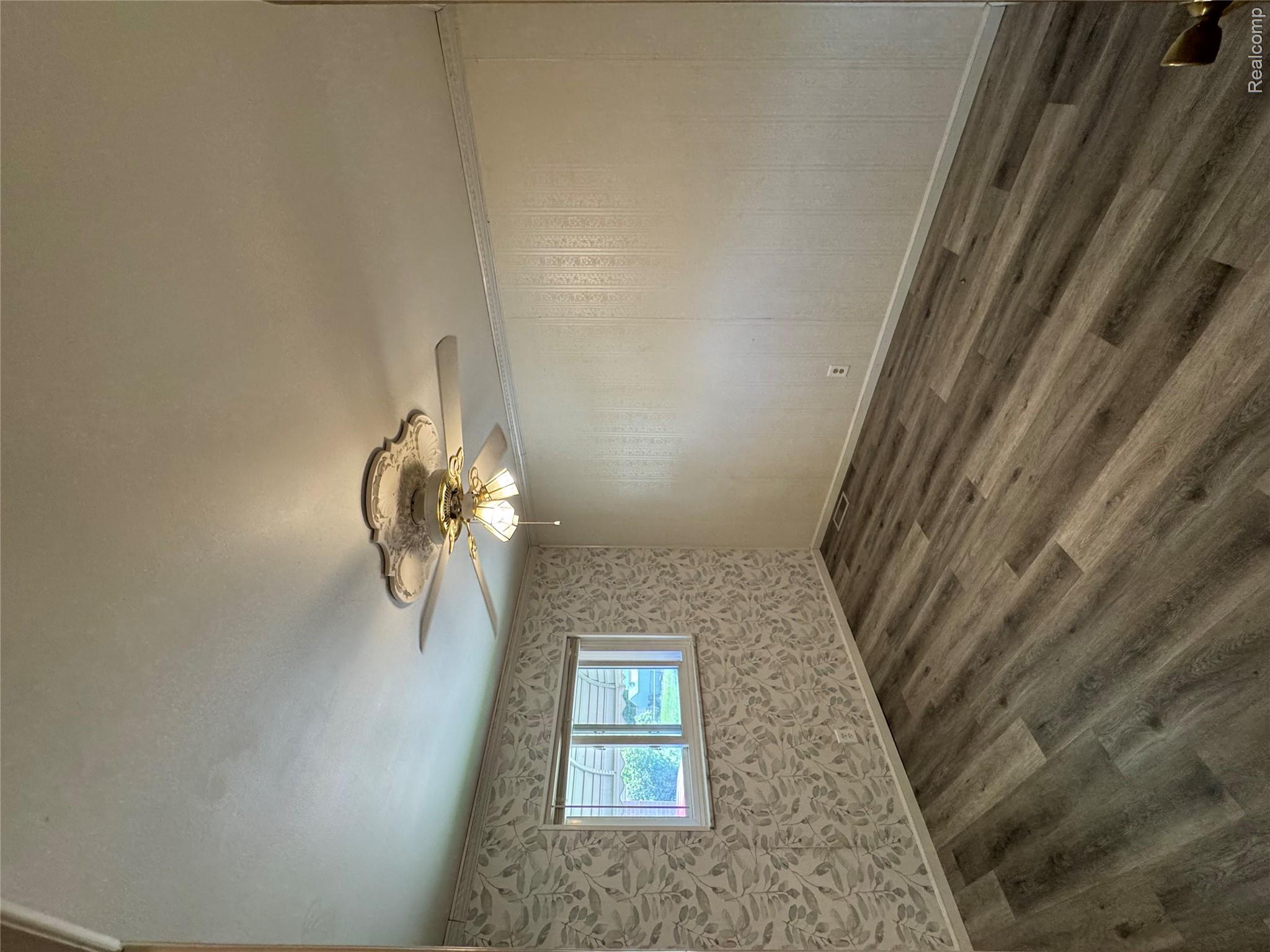 31263 Hayes Road Warren, MI 48088 - Photo 13 of 27 Unfurnished room with wallpapered walls, dark wood finished floors, and a ceiling fan
