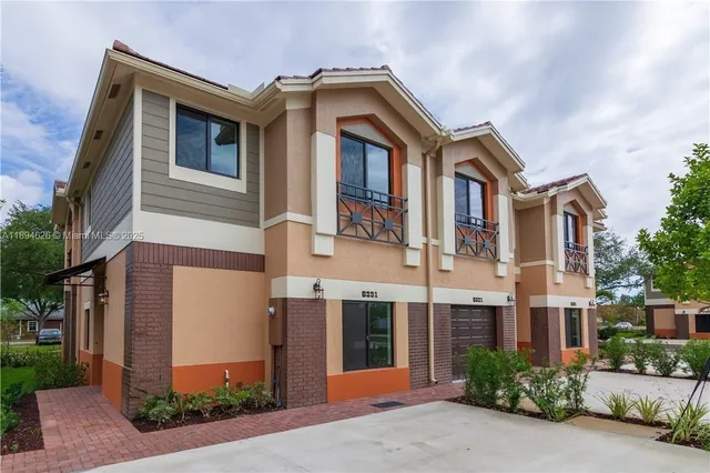 a front view of a building with garden