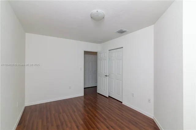 a view of a room with wooden floor and closet