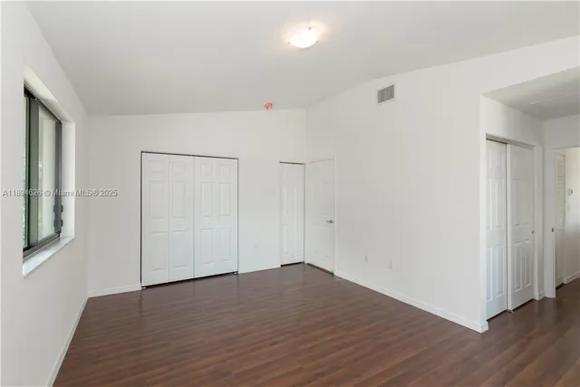 an empty room with wooden floor