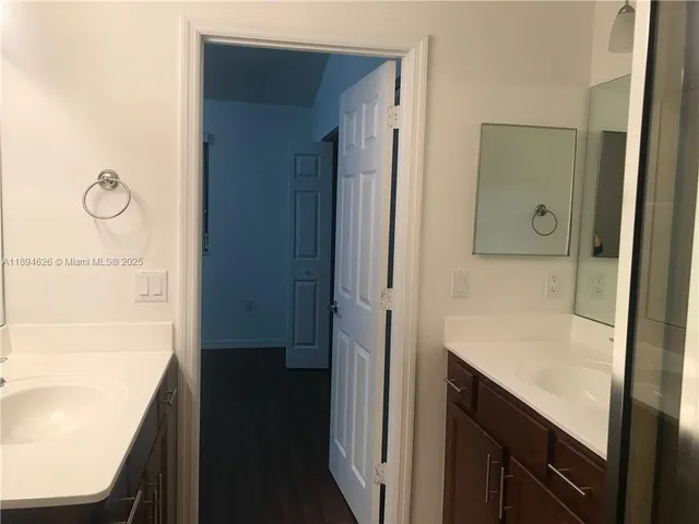 a bathroom with a shower and a sink