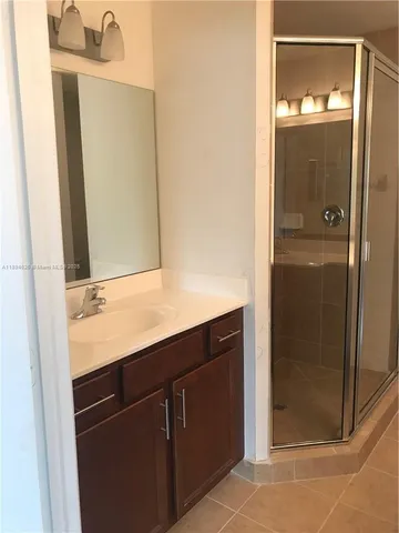 a bathroom with a shower and a sink