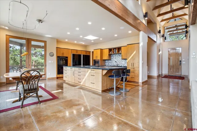 a living room filled with furniture and a large window