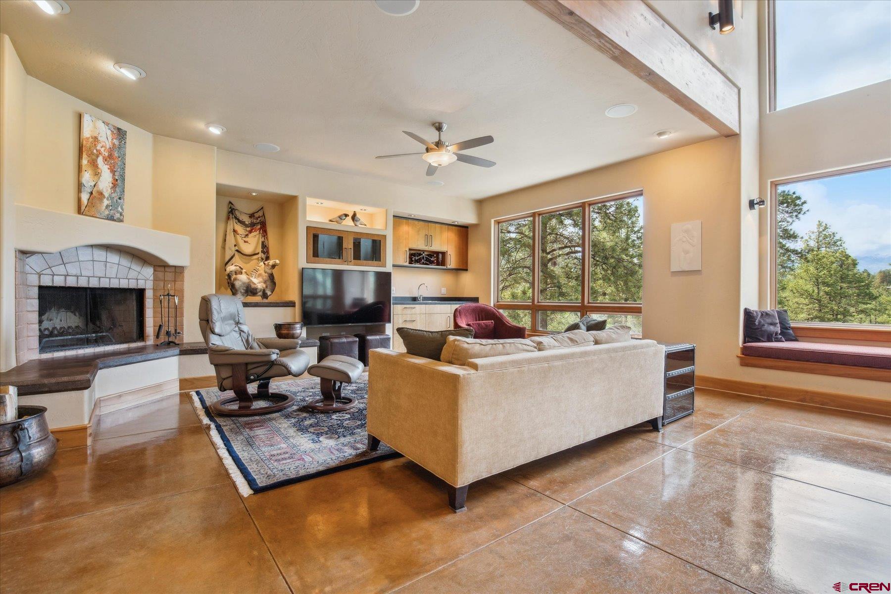 152 Peak Trail Drive Durango, CO 81303 - Photo 14 of 44 a living room with furniture large window and a fireplace