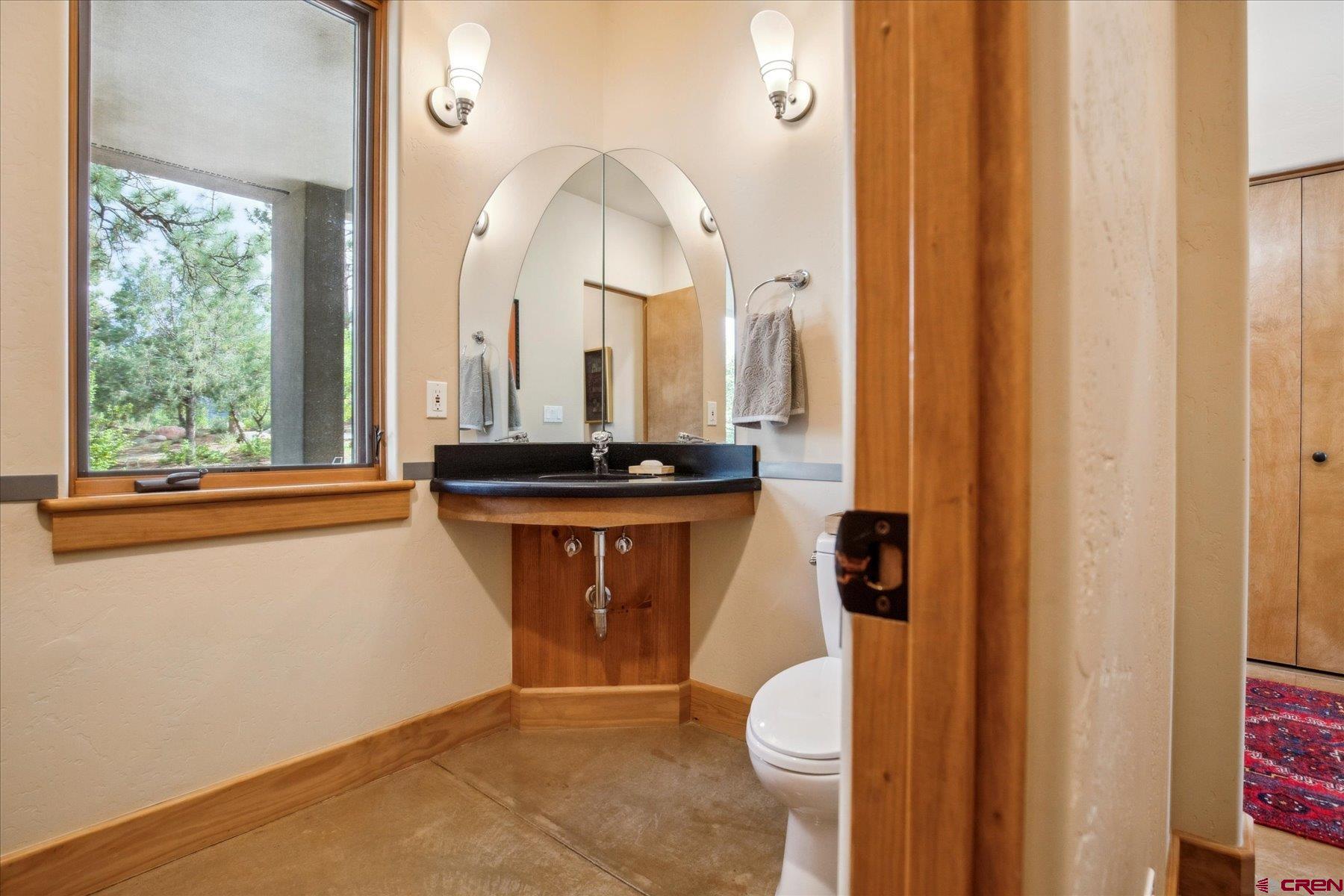152 Peak Trail Drive Durango, CO 81303 - Photo 19 of 44 a bathroom with a sink a toilet and a mirror