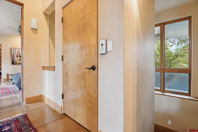a spacious bedroom with a bed and wooden floor