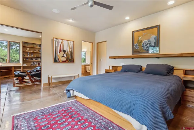 a bedroom with a bed and a large window