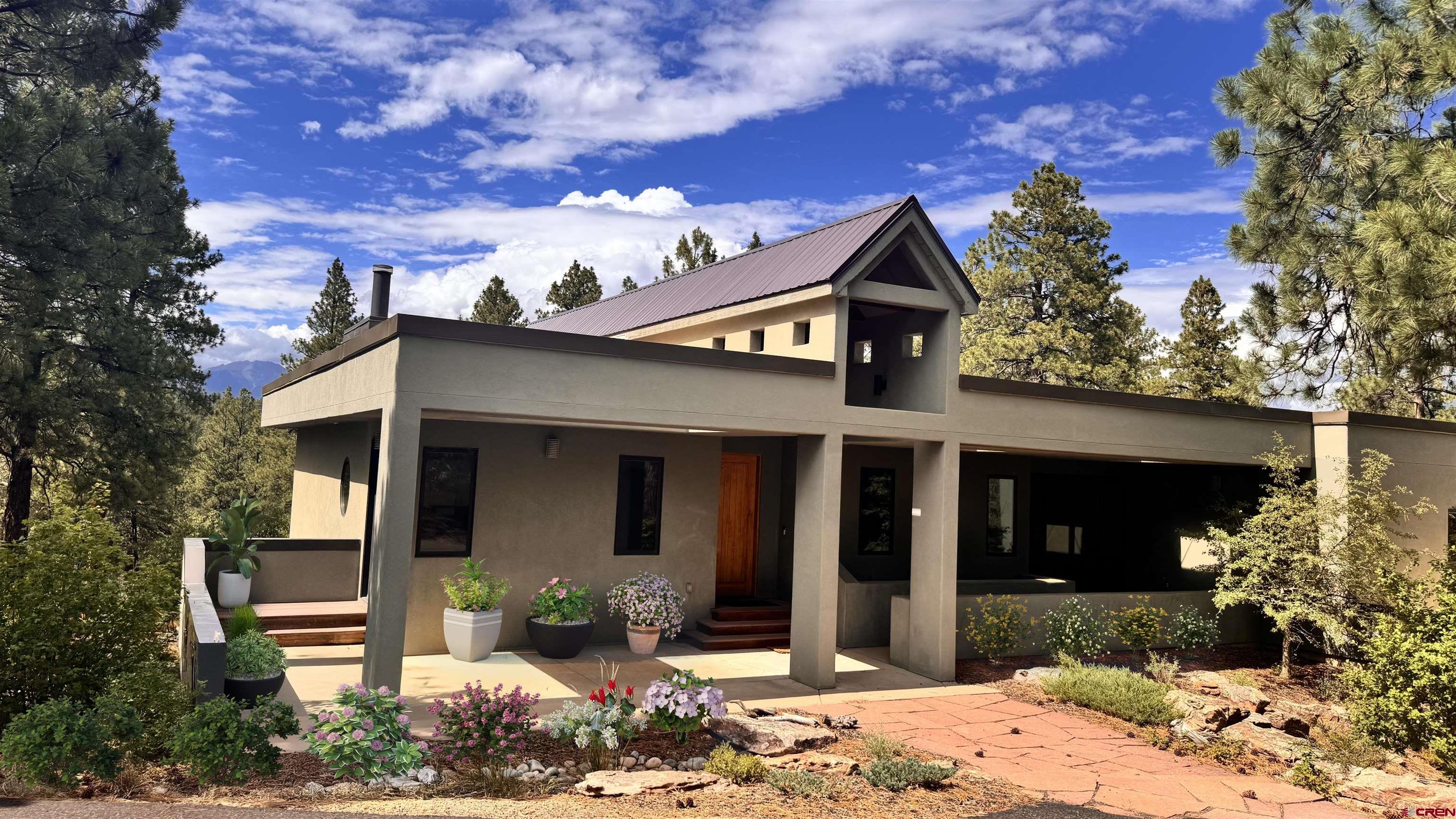 152 Peak Trail Drive Durango, CO 81303 - Photo 3 of 44 a front view of a house with a yard and garage