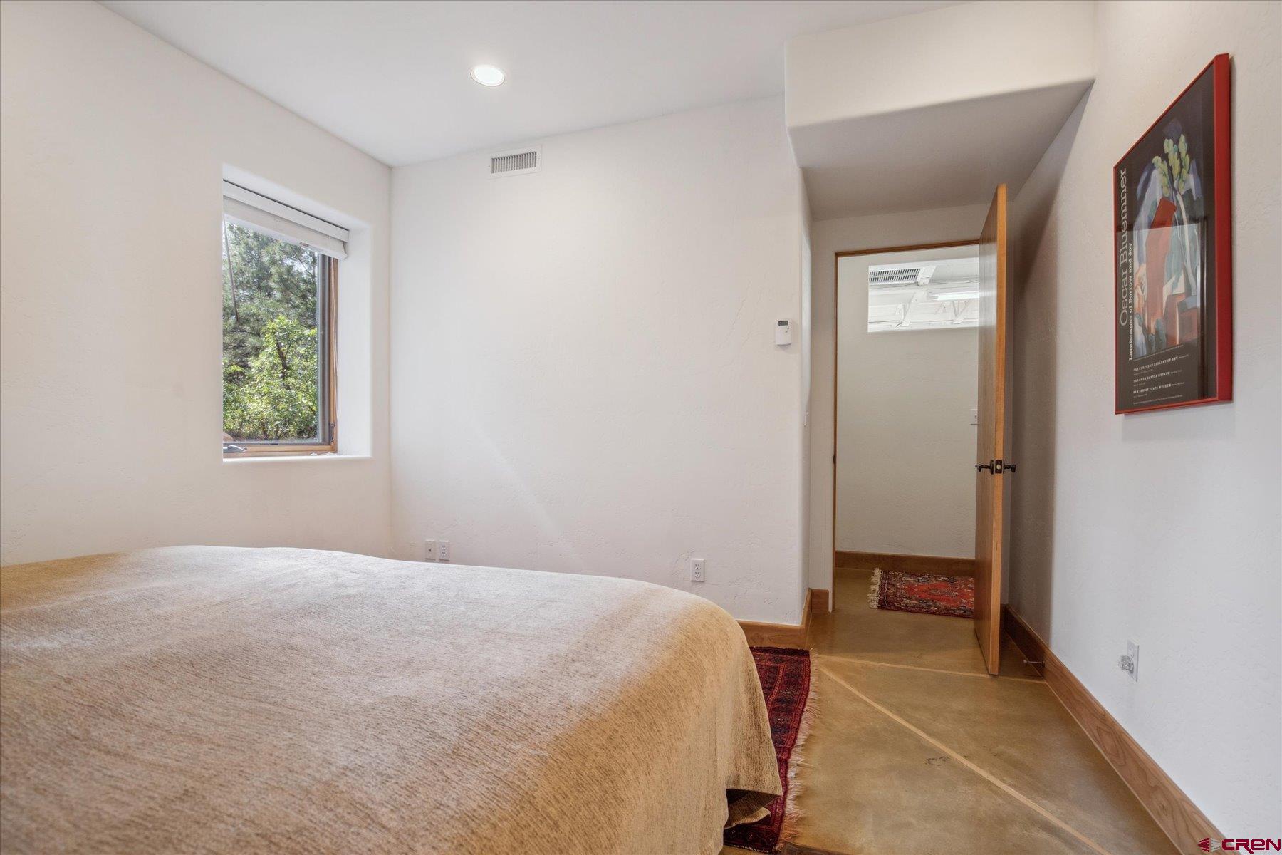 152 Peak Trail Drive Durango, CO 81303 - Photo 32 of 44 a bedroom with a bed and a window