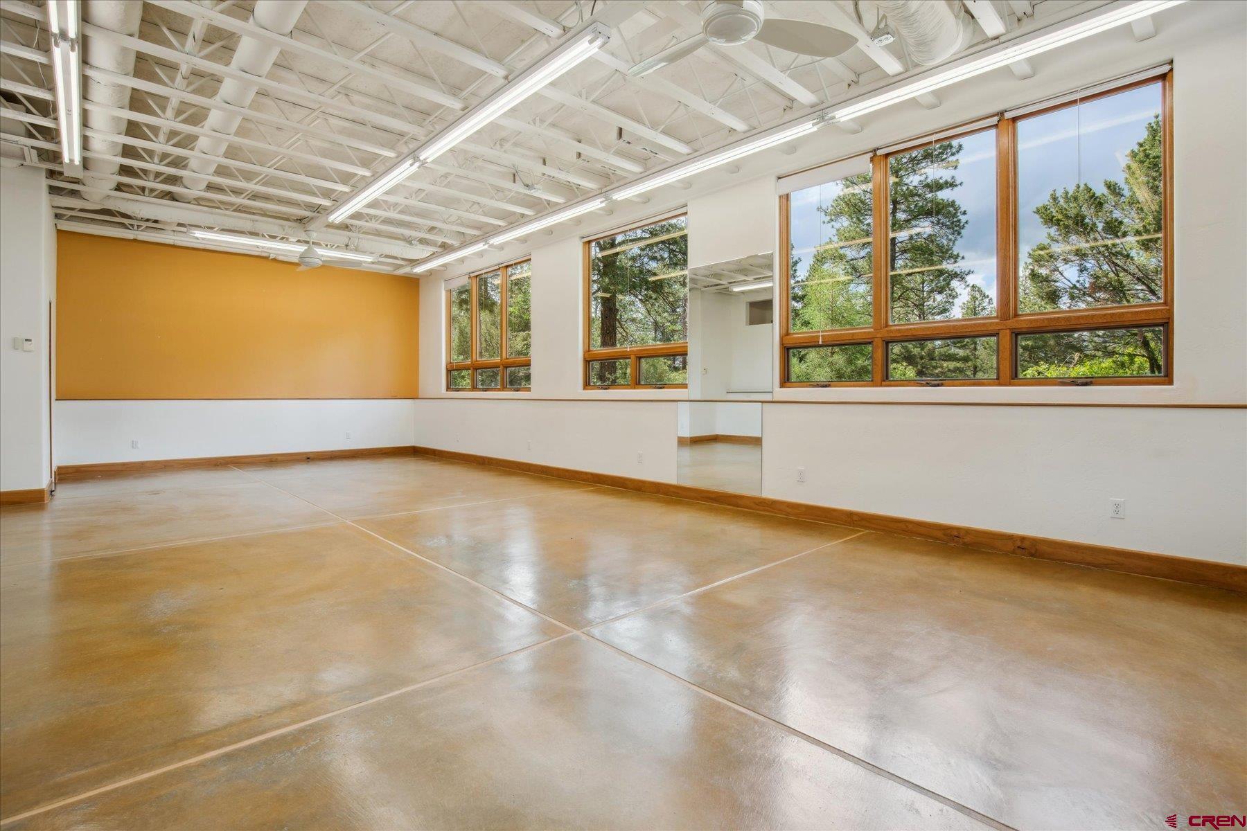 152 Peak Trail Drive Durango, CO 81303 - Photo 38 of 44 an empty room with wooden floor and windows