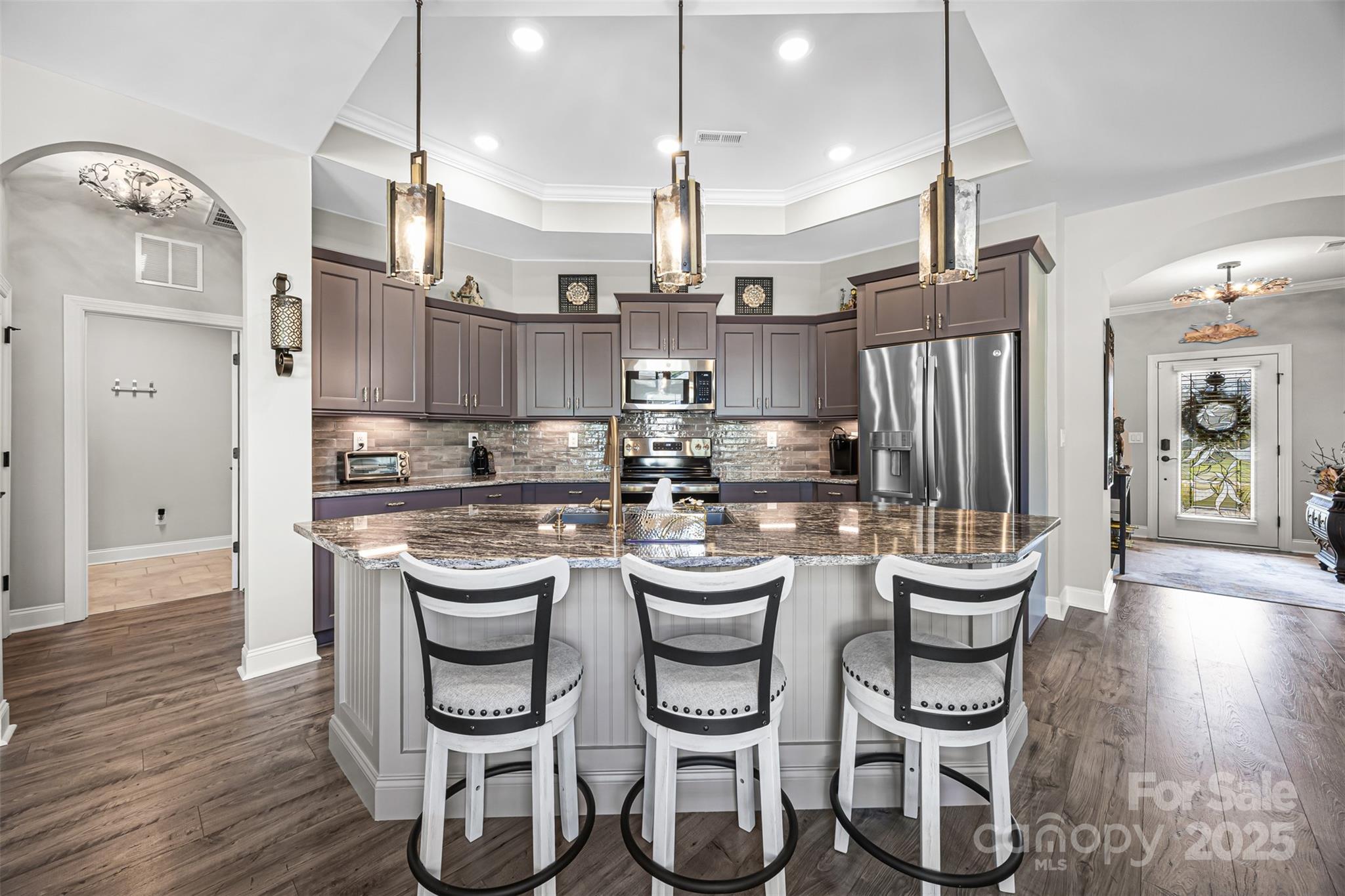16020 Clear Creek Farm Road Matthews, NC 28105 - Photo 11 of 42 a kitchen with white cabinets and stainless steel appliances