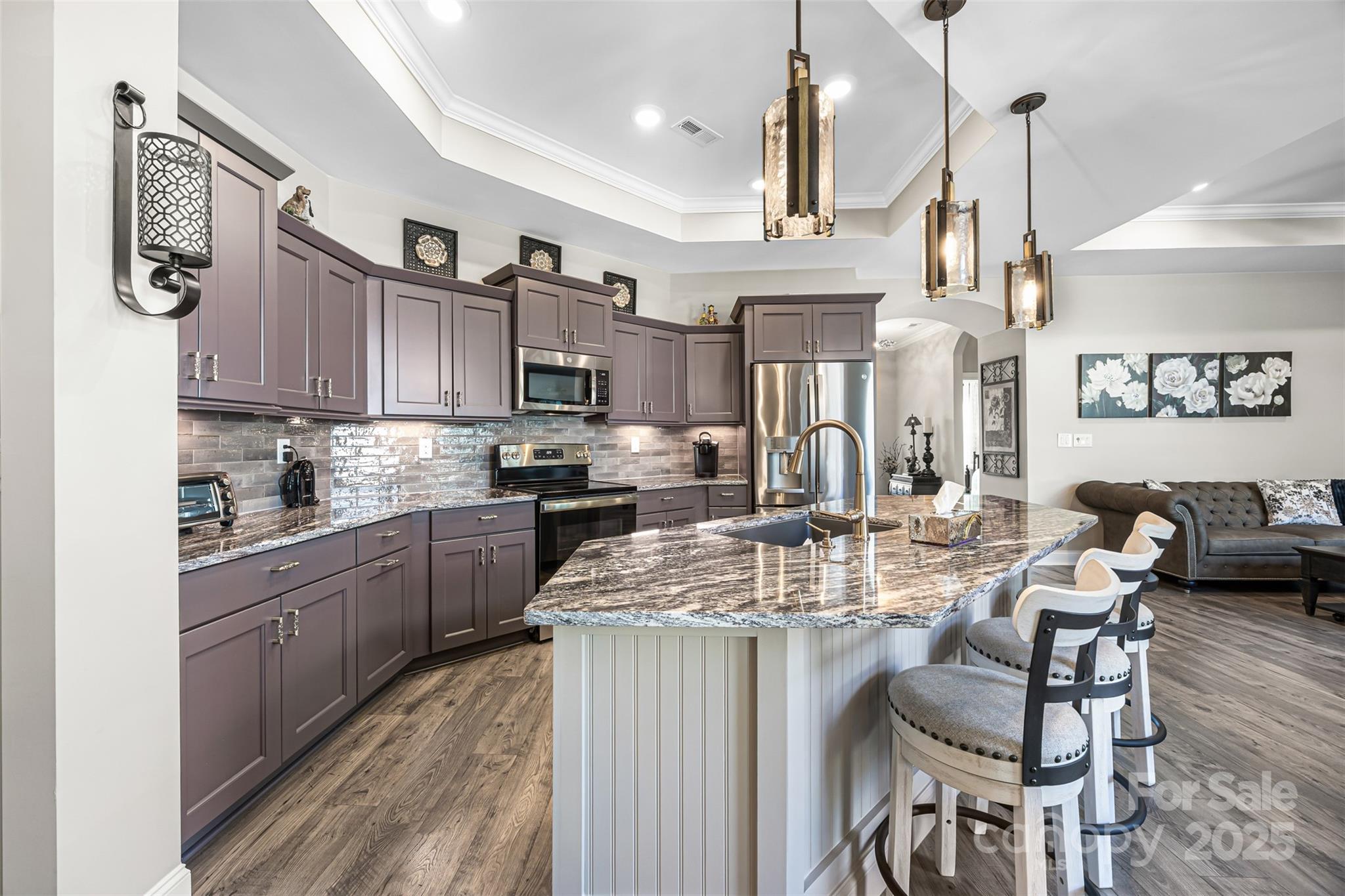 16020 Clear Creek Farm Road Matthews, NC 28105 - Photo 12 of 42 a kitchen with kitchen island granite countertop a sink cabinets and stainless steel appliances