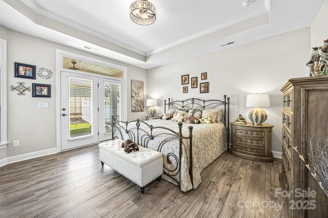 a bedroom with furniture and wooden floor