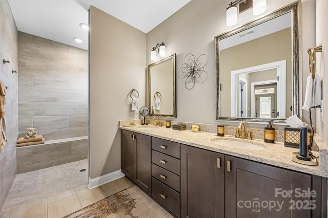 a bathroom with a double vanity sink and a mirror