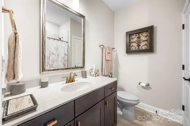 a bathroom with a toilet a sink and a mirror