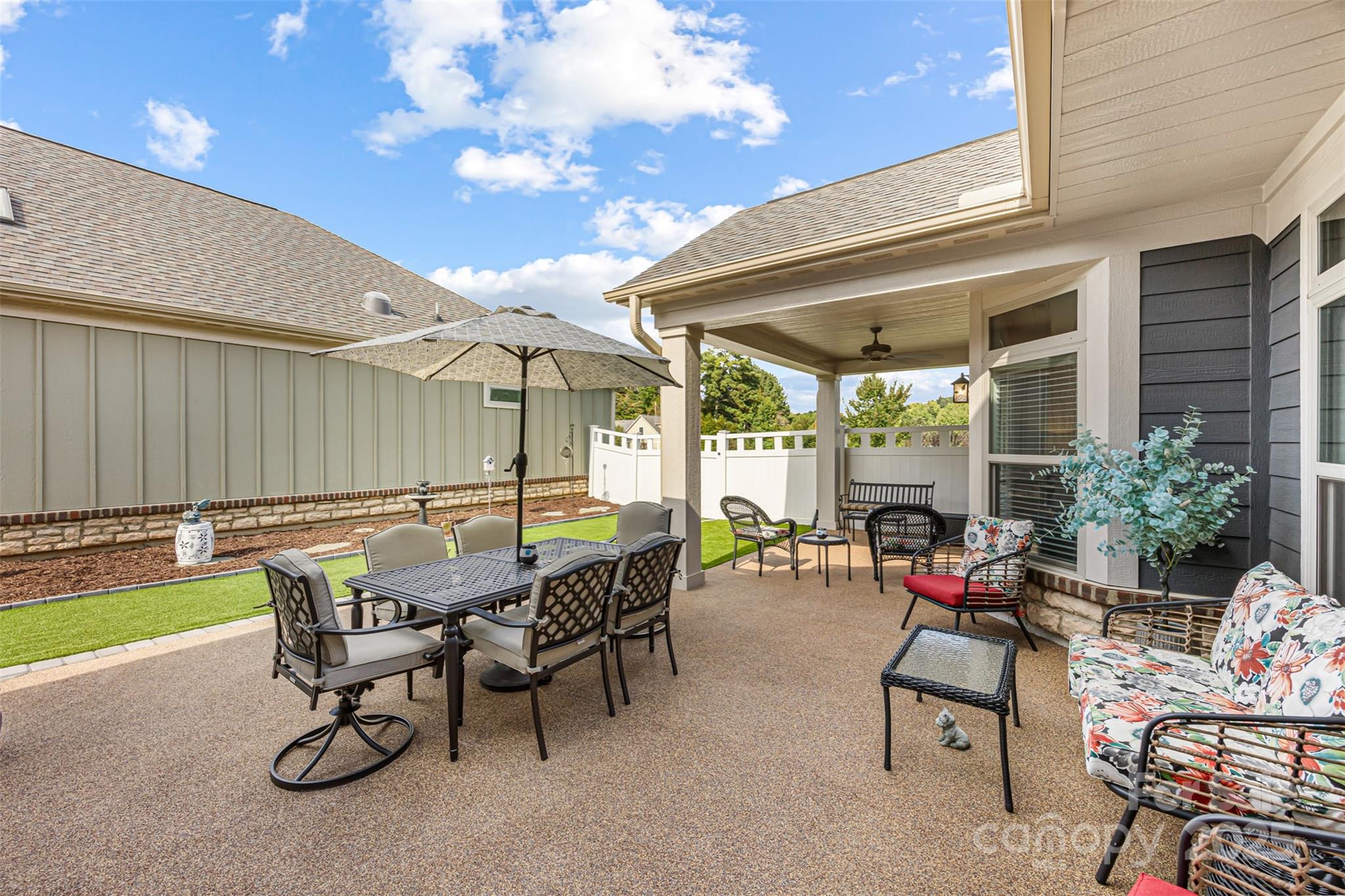 16020 Clear Creek Farm Road Matthews, NC 28105 - Photo 33 of 42 a view of a patio with table and chairs and potted plants