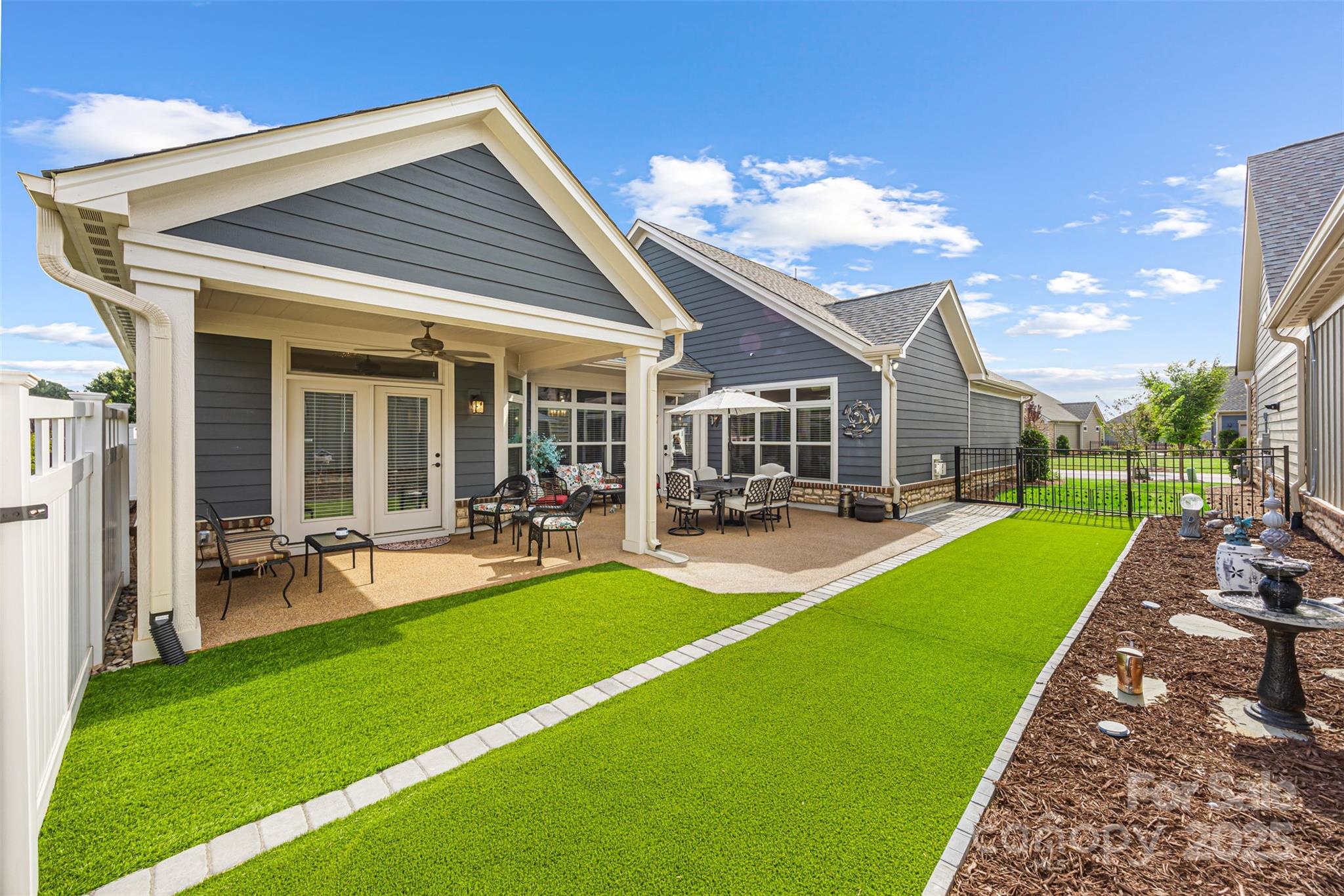 16020 Clear Creek Farm Road Matthews, NC 28105 - Photo 35 of 42 a view of a patio with dining table and chairs with a yard