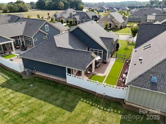an aerial view of a house with a yard basket ball court and outdoor seating