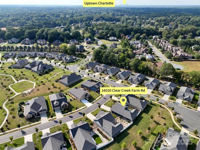an aerial view of a swimming pool yard and mountain view in back