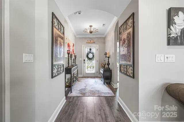 a view of a hallway view with wooden floor and living room