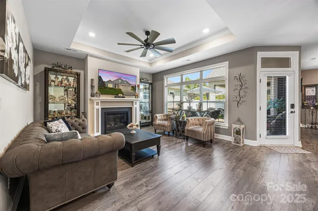 a living room with furniture a fireplace and a flat screen tv
