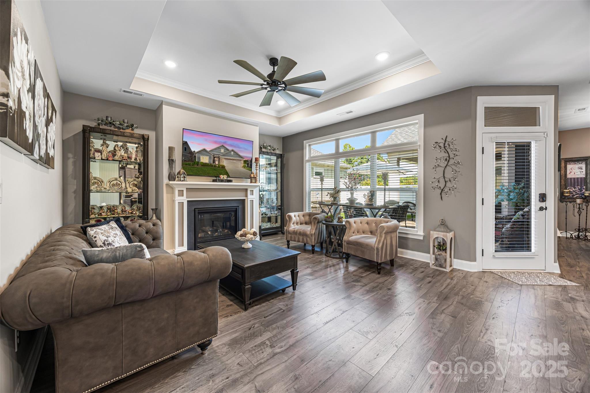 16020 Clear Creek Farm Road Matthews, NC 28105 - Photo 6 of 42 a living room with furniture a fireplace and a flat screen tv